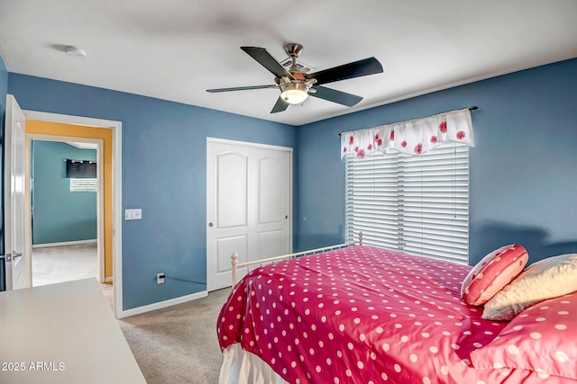 carpeted bedroom with ceiling fan and a closet