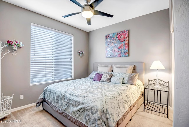 carpeted bedroom with ceiling fan and multiple windows