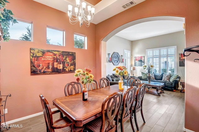 dining room with an inviting chandelier and hardwood / wood-style flooring