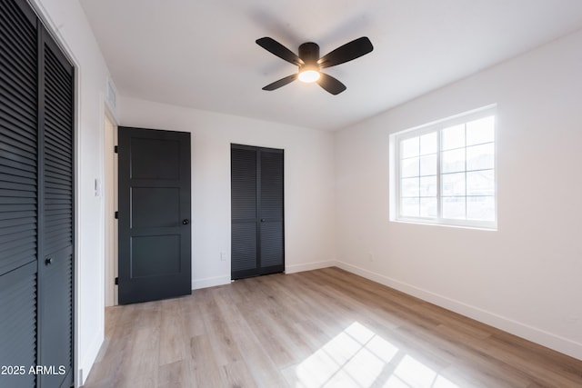 unfurnished bedroom featuring ceiling fan, light wood-type flooring, and a closet