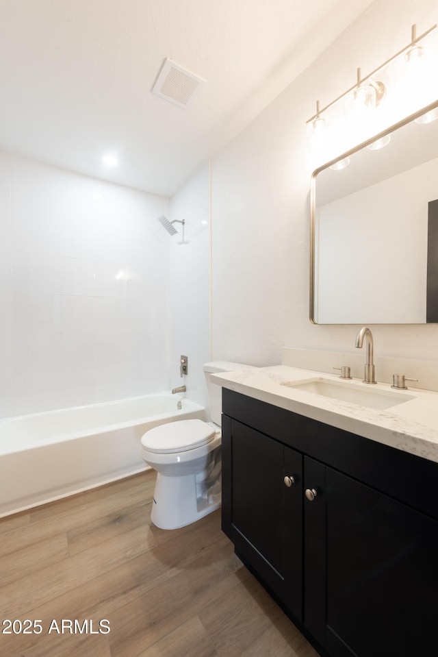 full bathroom featuring toilet, wood-type flooring, shower / washtub combination, and vanity