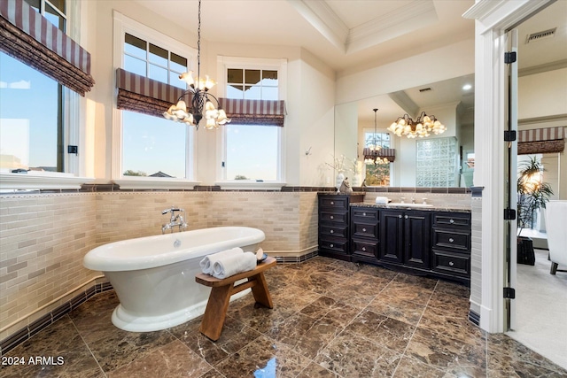 bathroom featuring ornamental molding, a bath, tile walls, and an inviting chandelier