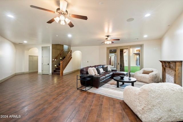 living room featuring dark hardwood / wood-style floors and ceiling fan