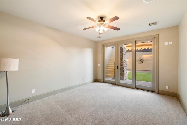 carpeted spare room featuring ceiling fan