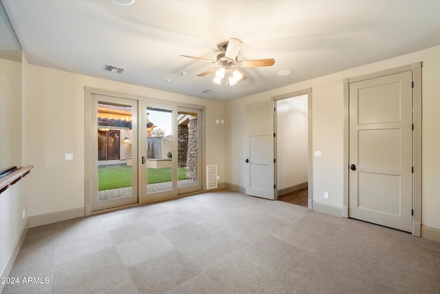 unfurnished room with ceiling fan and light colored carpet