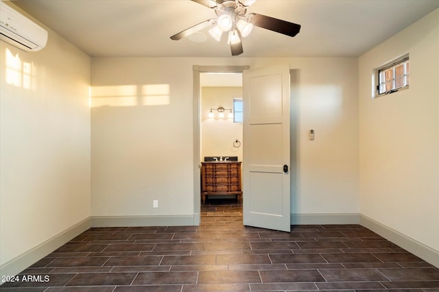 unfurnished bedroom with ceiling fan, dark hardwood / wood-style floors, and a wall mounted AC