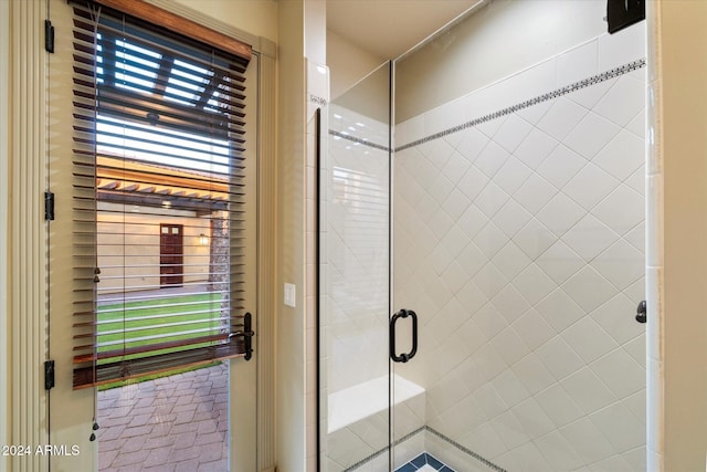 bathroom with a shower with door