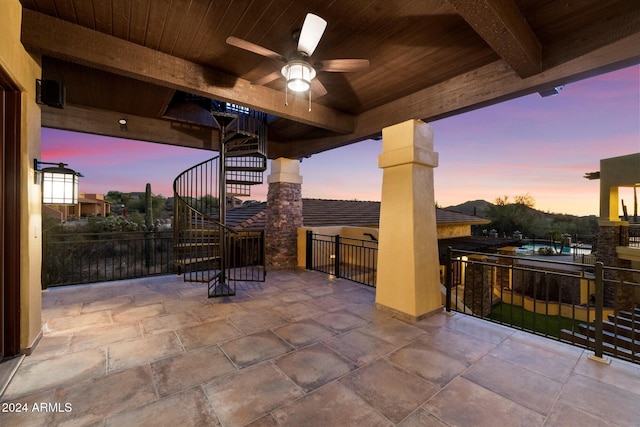 patio terrace at dusk featuring ceiling fan