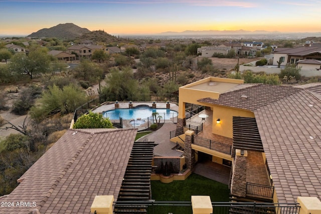 aerial view at dusk featuring a mountain view