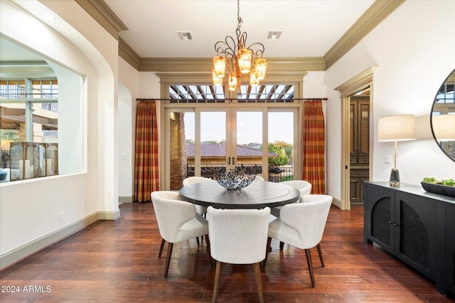 dining area featuring dark hardwood / wood-style floors, plenty of natural light, crown molding, and a chandelier