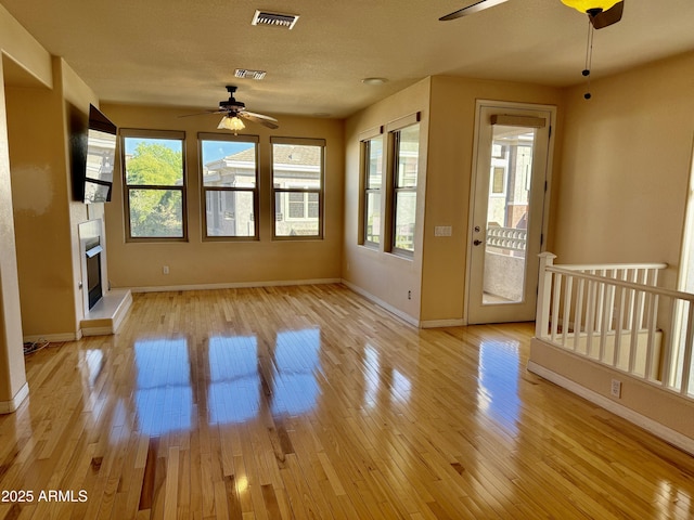 interior space with ceiling fan