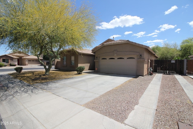 view of front of property with fence, stucco siding, driveway, and an attached garage