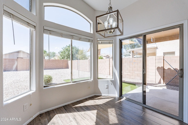 dining room featuring an inviting chandelier, hardwood / wood-style floors, and a healthy amount of sunlight