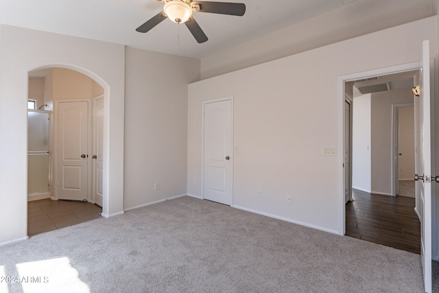 interior space featuring ceiling fan and light colored carpet