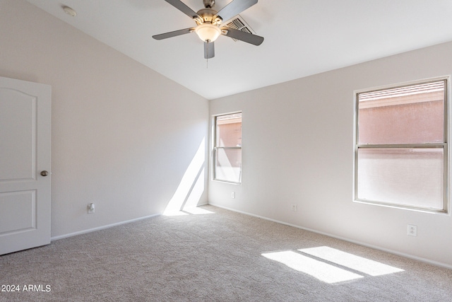 carpeted empty room featuring ceiling fan and vaulted ceiling