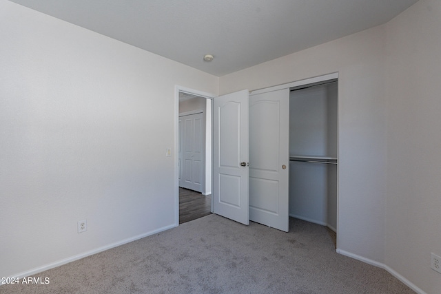 unfurnished bedroom featuring a closet and carpet flooring