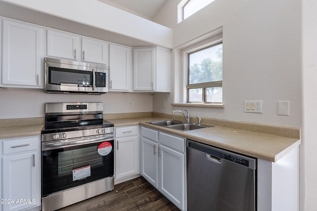 kitchen featuring stainless steel appliances, white cabinetry, and sink