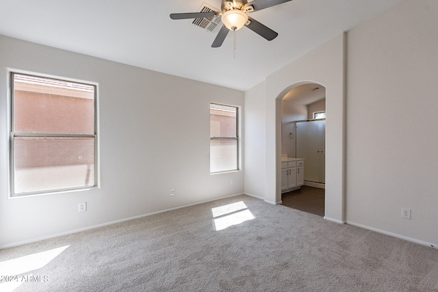 carpeted spare room with ceiling fan