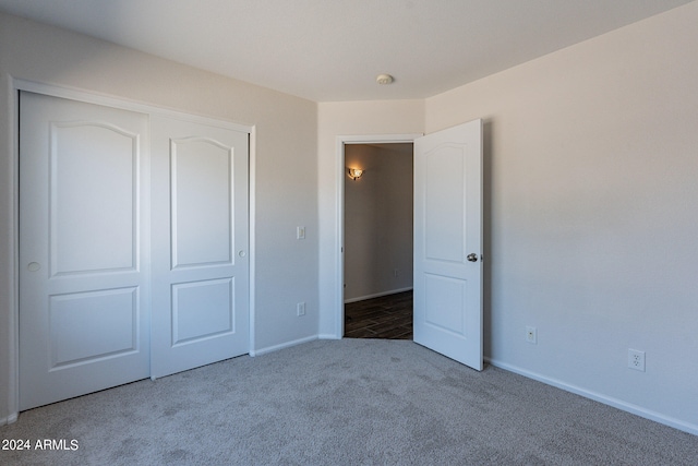 unfurnished bedroom featuring a closet and carpet