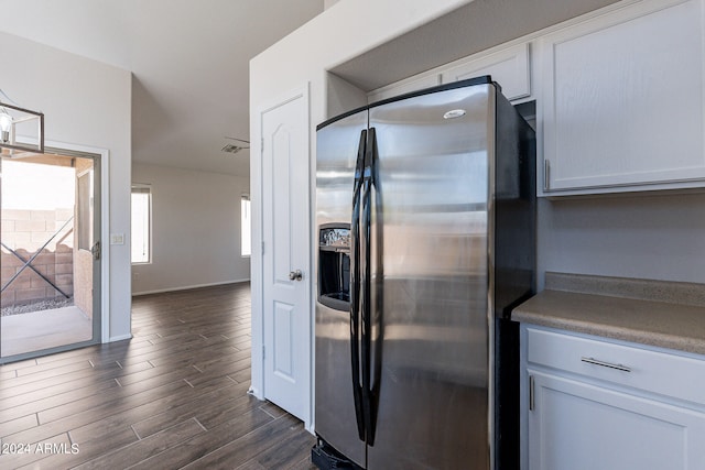 kitchen featuring stainless steel refrigerator with ice dispenser, white cabinetry, and dark hardwood / wood-style floors