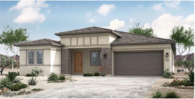 prairie-style home with driveway, an attached garage, and stucco siding