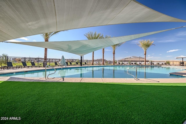 view of pool featuring a yard and a patio