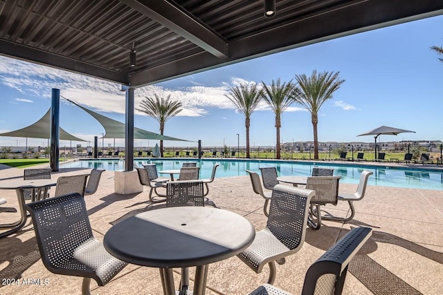 view of patio featuring fence and a community pool