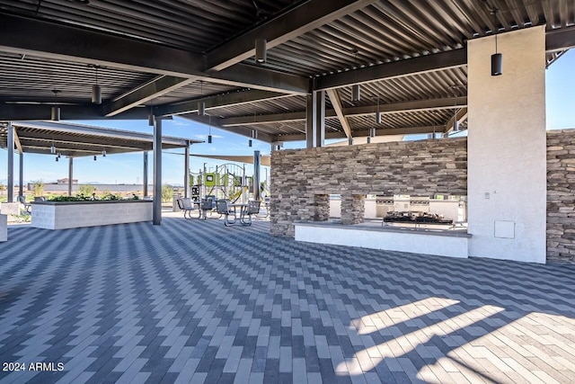 view of patio featuring a stone fireplace