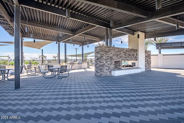 view of patio / terrace with fence and a multi sided fireplace