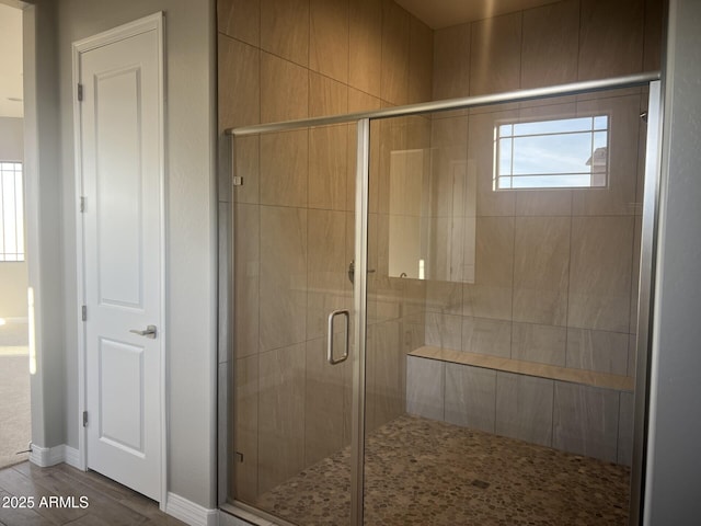 bathroom featuring a stall shower and wood finished floors