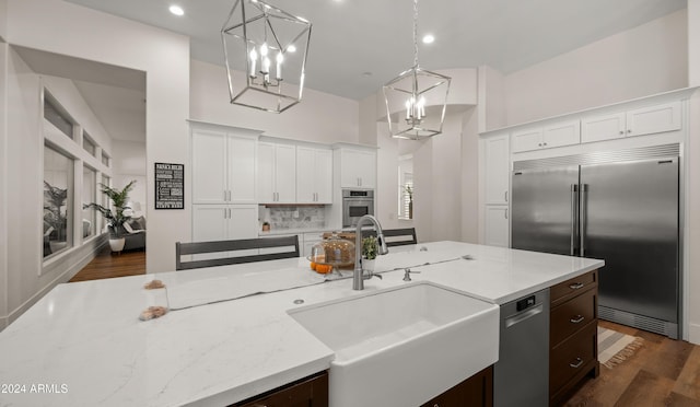6429 S Honor Ct, Gilbert, AZ 85298 - kitchen with stainless steel appliances, a sink, white cabinets, pendant lighting, and dark wood-type flooring