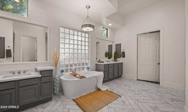 6429 S Honor Ct, Gilbert, AZ 85298 - full bath with healthy amount of natural light, two vanities, a freestanding bath, and a towering ceiling