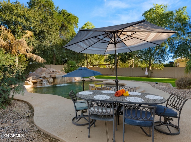 view of patio / terrace with a fenced in pool, outdoor dining area, and a fenced backyard