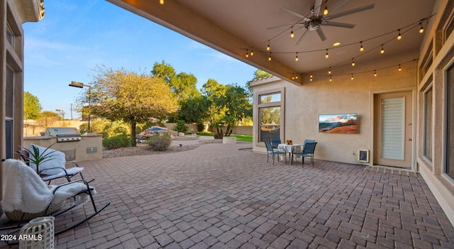 view of patio / terrace with ceiling fan, an outdoor kitchen, and area for grilling