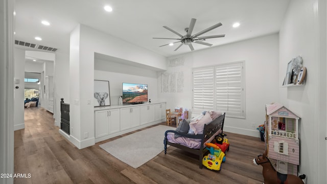 living room with hardwood / wood-style floors and ceiling fan