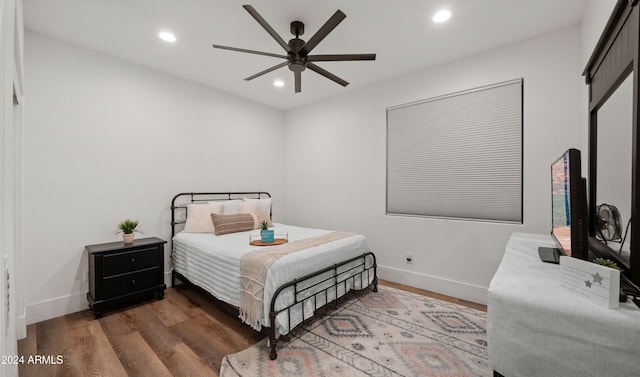 bedroom featuring ceiling fan and dark hardwood / wood-style flooring