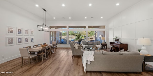 6429 S Honor Ct, Gilbert, AZ 85298 - living room featuring wood finished floors, recessed lighting, and a chandelier