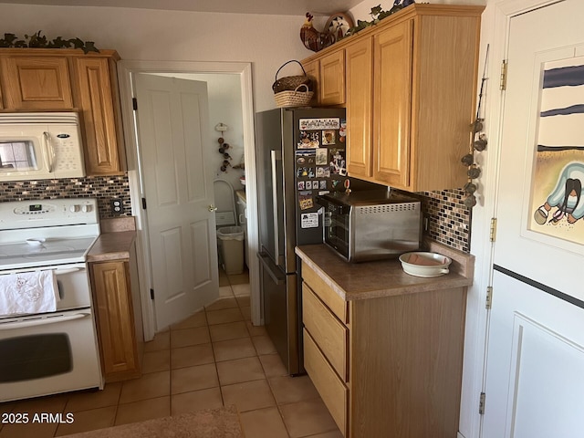 kitchen with tasteful backsplash, appliances with stainless steel finishes, and light tile patterned floors