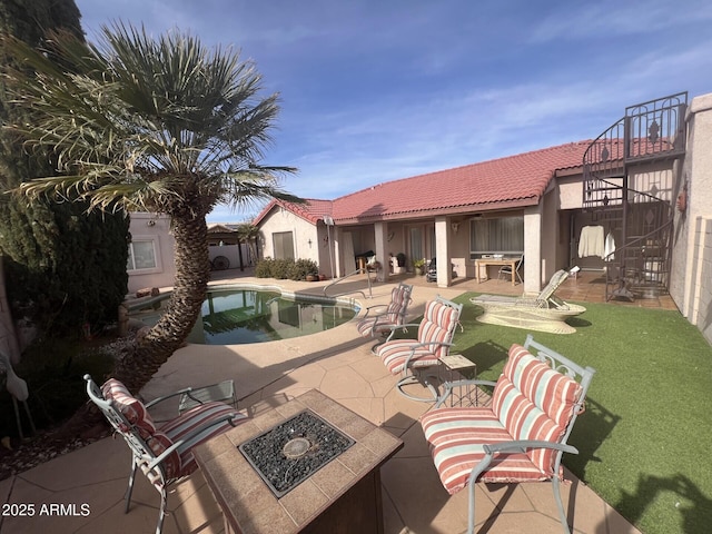 view of pool with a patio and a fire pit