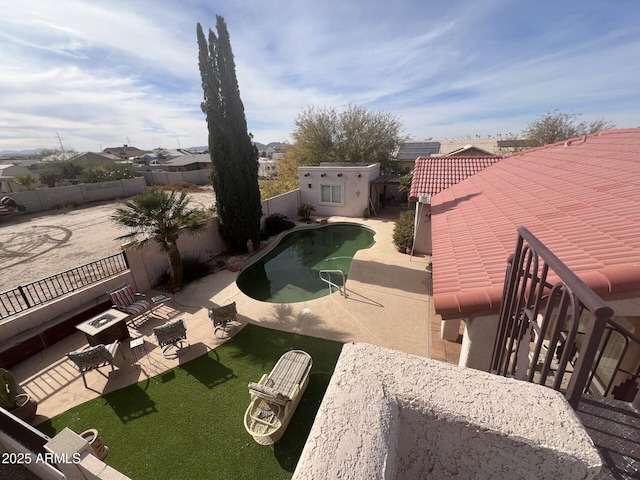 exterior space with a fenced in pool and an outdoor fire pit