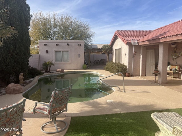 view of swimming pool with a patio and an outdoor structure