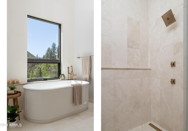 bathroom featuring a soaking tub and a tile shower