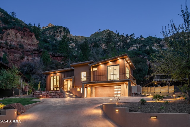 view of front of house with a garage, a mountain view, and driveway