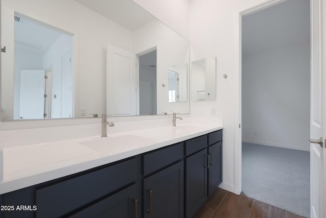 bathroom with vanity and wood-type flooring