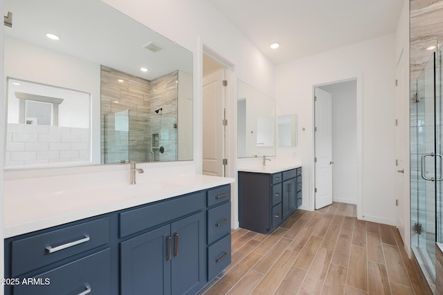 bathroom with an enclosed shower and vanity