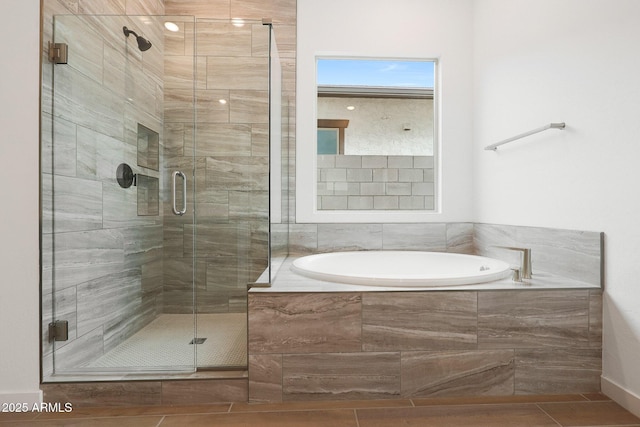 bathroom featuring separate shower and tub