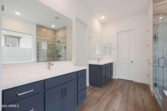 bathroom with an enclosed shower and vanity