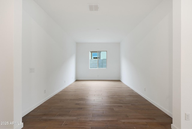 empty room featuring dark wood-type flooring