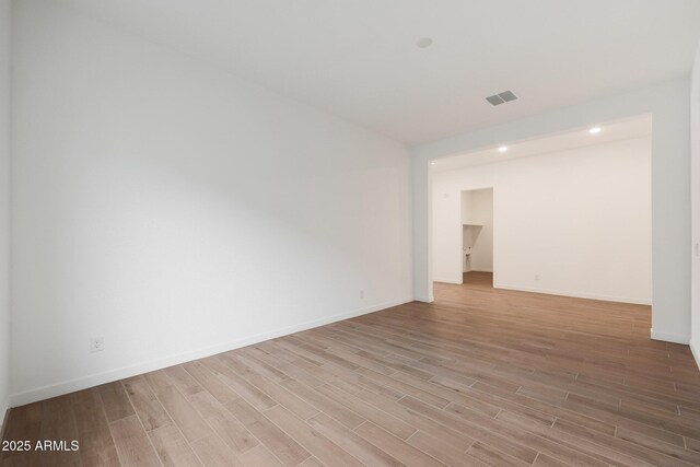 unfurnished room with light wood-type flooring