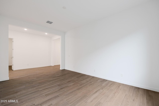 unfurnished room featuring hardwood / wood-style flooring